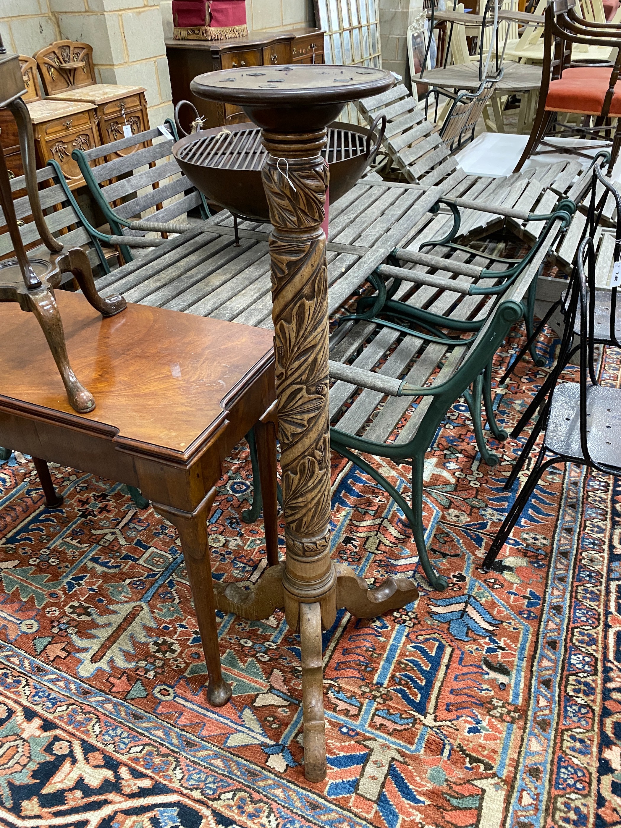 A Victorian style carved mahogany torchere, (formerly a bedpost)